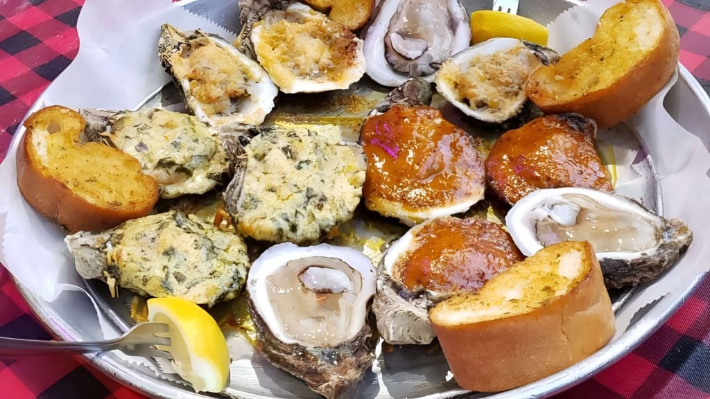 Charbroiled oysters topped with garlic butter and cheese, served with French bread at Gallier’s Restaurant & Oyster Bar