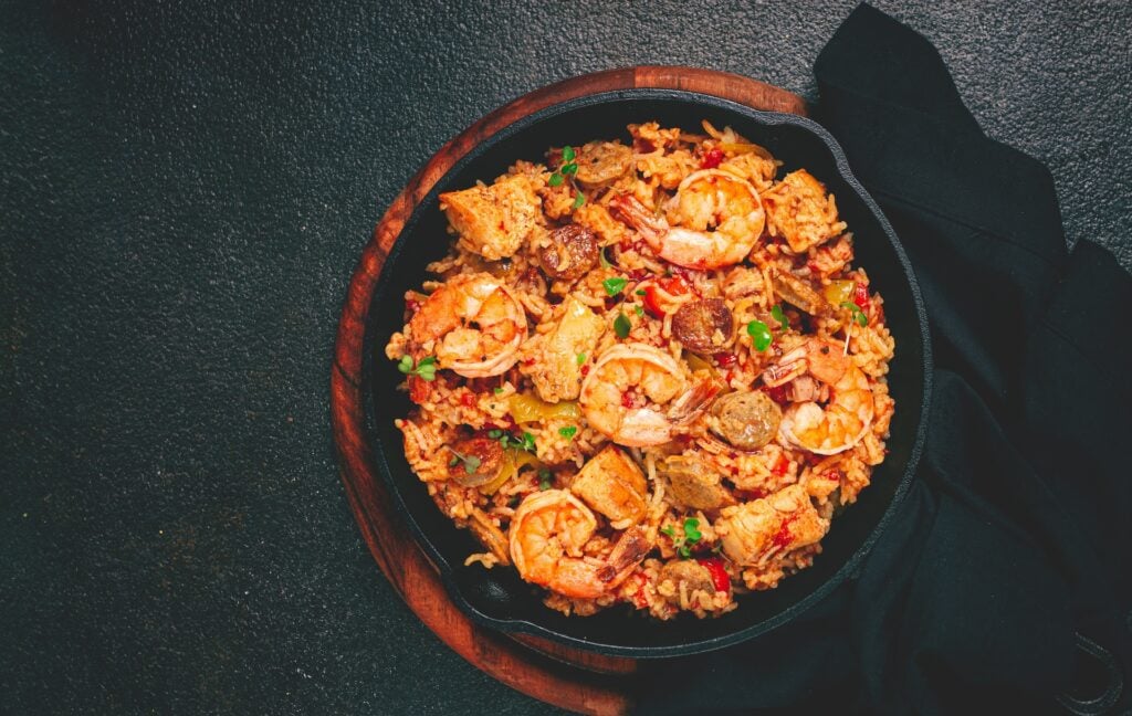 Creole Jambalaya vs. Cajun Jambalaya: What’s the Difference? 1 Creole-style jambalaya with shrimp, sausage, and vegetables served in a cast iron skillet