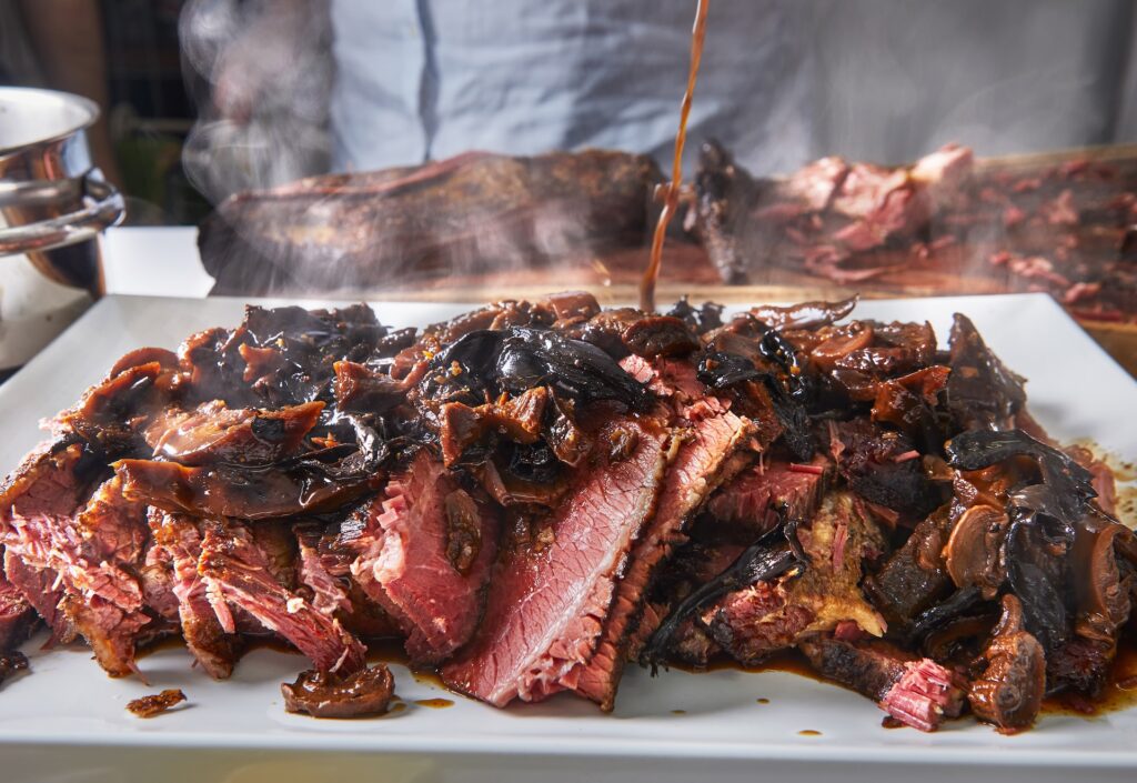 Top Southern Cooking Techniques You Can Try at Home 3 Juicy, slow-smoked beef brisket topped with caramelized onions and served hot