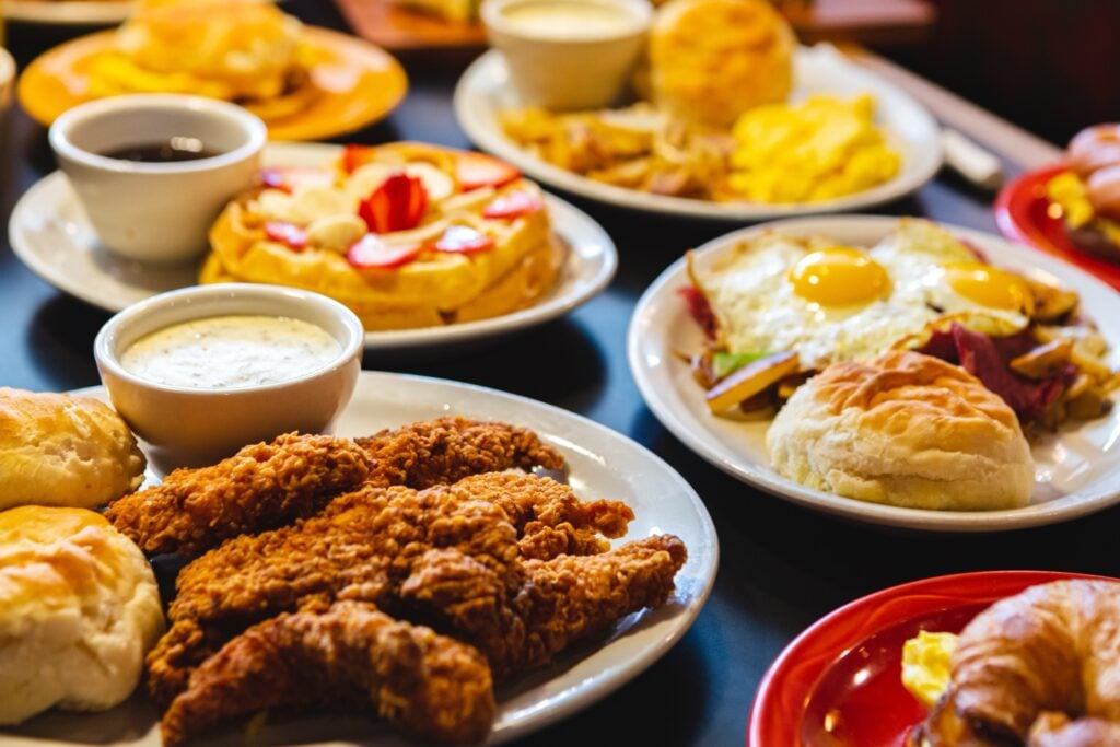 Assorted Cajun and Southern brunch dishes served family-style at a New Orleans table