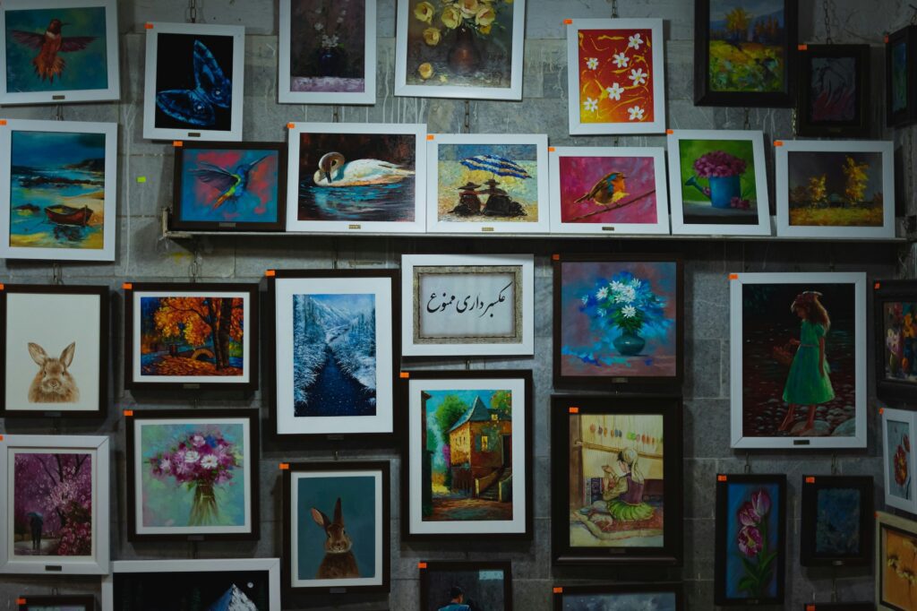 Colorful framed paintings on a gallery wall