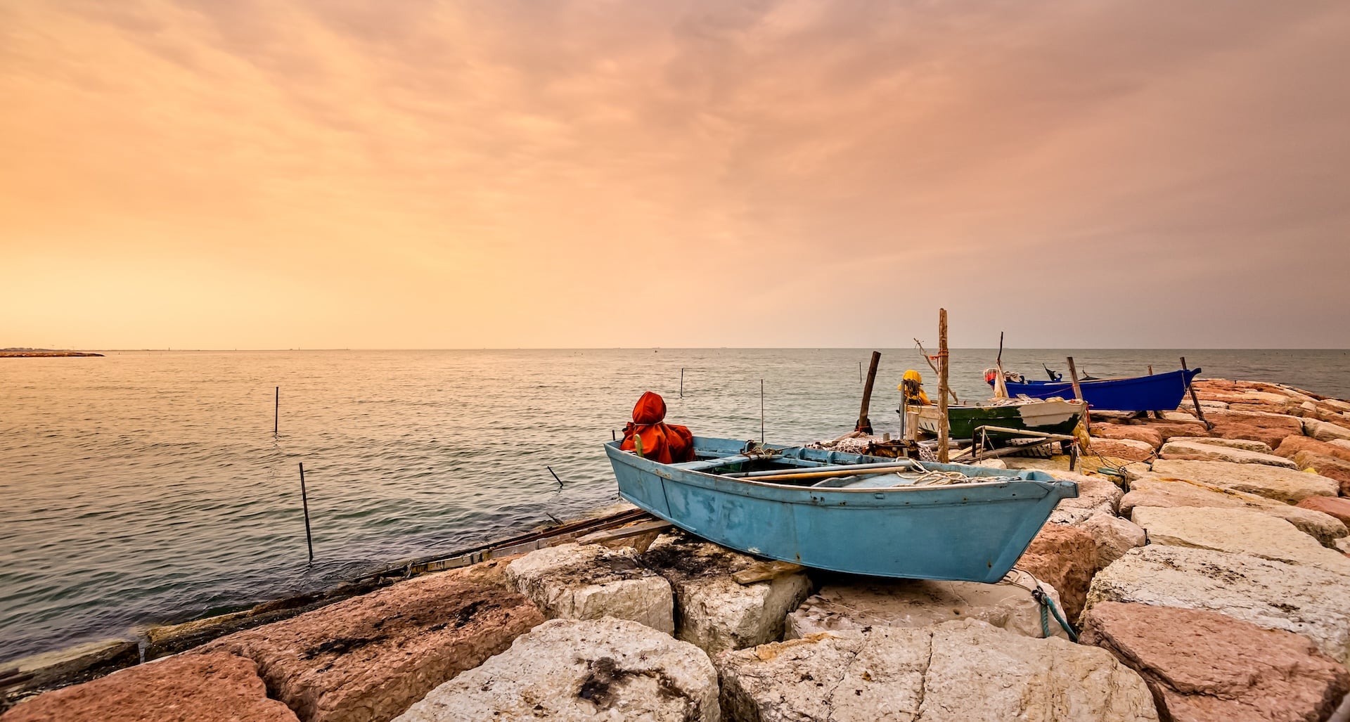 Small fishing boats anchored by the Gulf coast at sunset