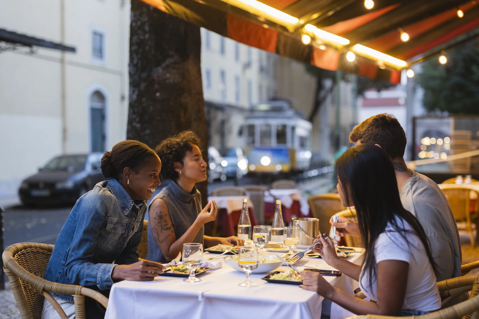 Group enjoying seafood meal at outdoor restaurant in New Orleans