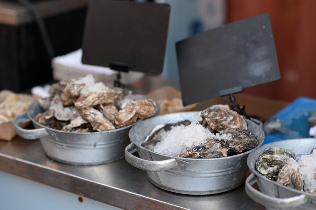 The History of Oyster Bars in New Orleans 1 Fresh oysters displayed on ice at a traditional New Orleans seafood market