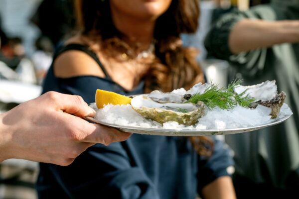 Freshly shucked oysters served on ice with lemon, a classic New Orleans oyster bar presentation