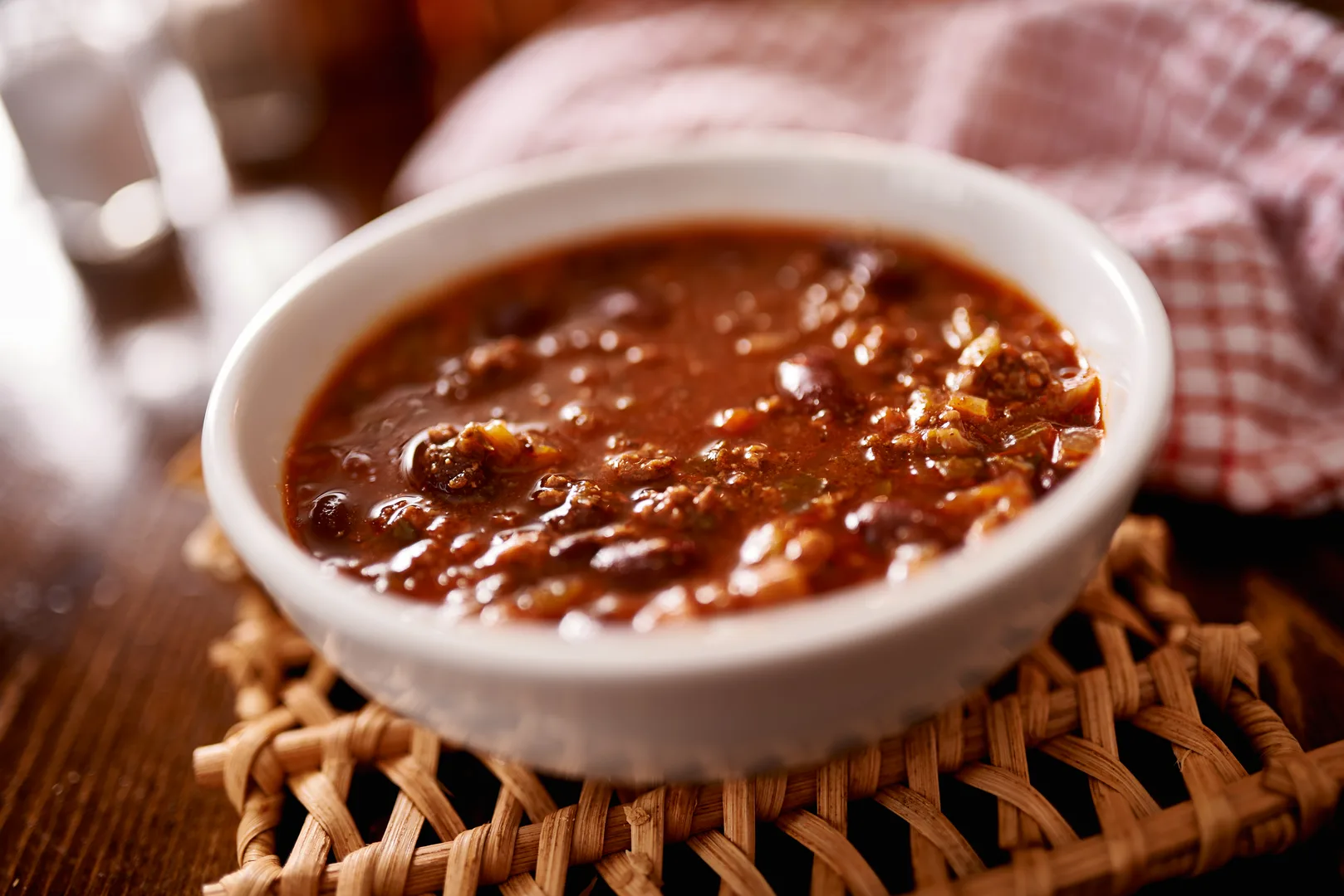 Rich dark roux gumbo stew in a white bowl