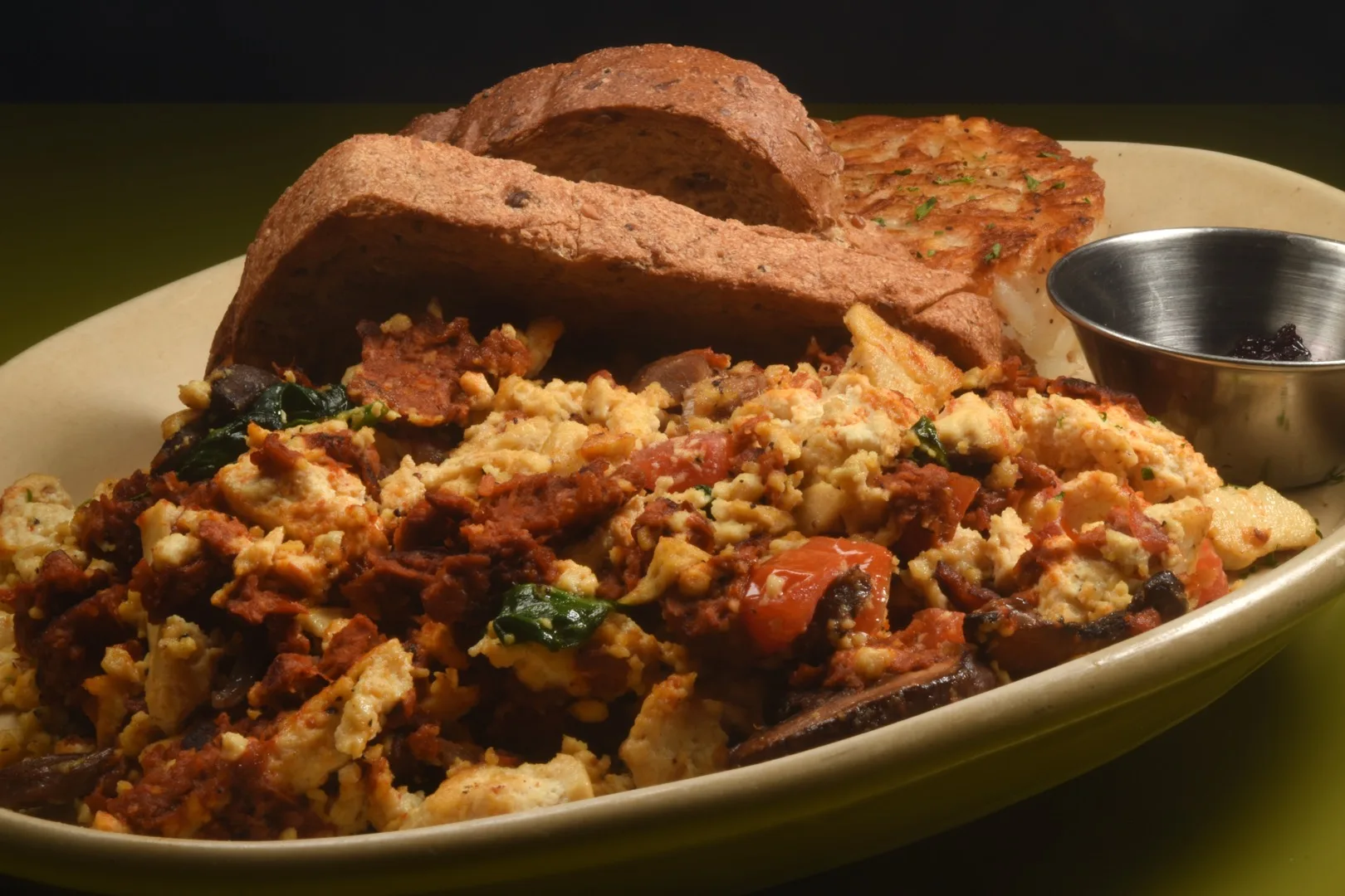 New Orleans brunch table spread with Cajun dishes, oysters, and fresh juice