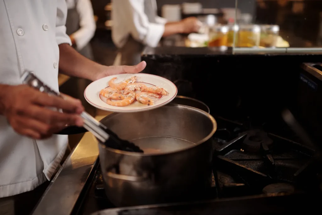 Chef preparing Gulf shrimp for a private dining event at Gallier's in New Orleans