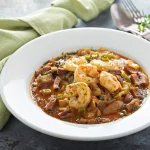 Shrimp and grits with andouille sausage in a rich Cajun gravy