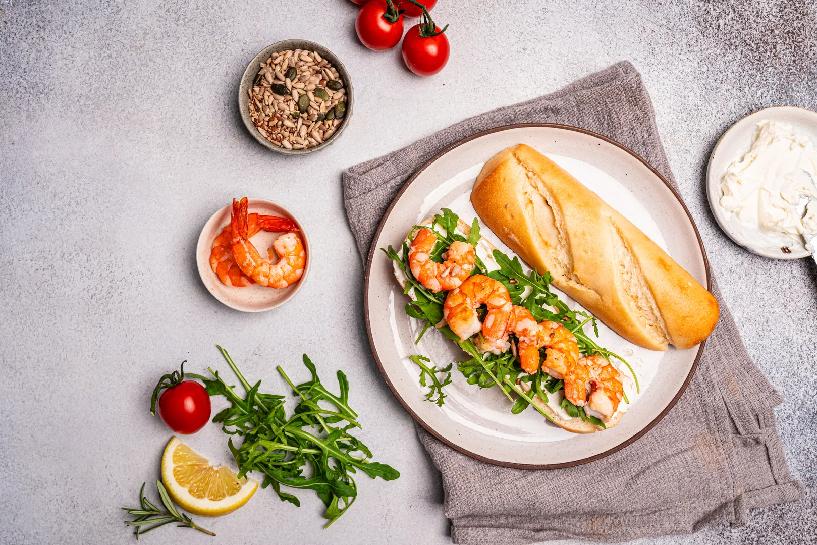 Shrimp sandwich on crusty French bread with arugula and fresh ingredients