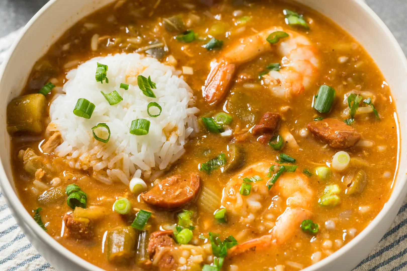 Cajun gumbo stew with shrimp sausage okra and white rice in a bowl