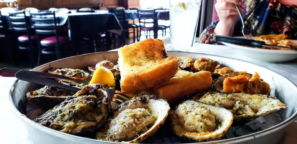 Seafood Restaurant Near the French Quarter 2 Charbroiled oysters with garlic bread at a New Orleans restaurant near the French Quarter